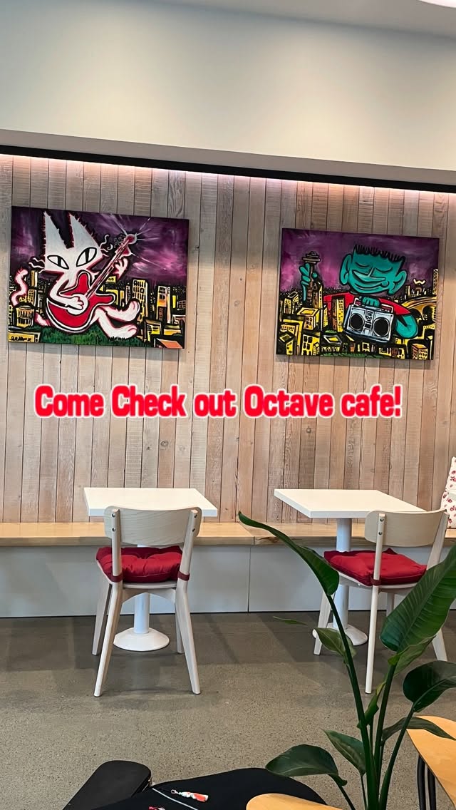 Hand-painted cat murals above the tables